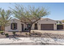 Charming single-story home featuring a well-manicured lawn, a two-car garage, and desert landscaping at 10199 W Cottontail Ln, Peoria, AZ 85383