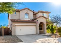 Charming two-story home with a spacious two car garage, desert landscaping and an American flag at 12055 W Nadine Way, Peoria, AZ 85383
