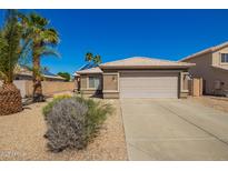 Charming single-story home with a two car garage and desert landscaping with beautiful palm trees at 12622 W Catalina Dr, Avondale, AZ 85392
