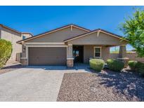 Charming single-story home featuring a well-manicured lawn, desert landscaping, and a two-car garage at 13455 N 142Nd Ave, Surprise, AZ 85379