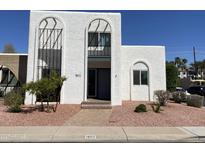 Bright white exterior features a unique architectural design, desert landscaping, and a welcoming entryway at 1802 W Citrus Way, Phoenix, AZ 85015