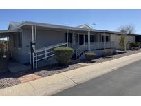 Charming home with covered porch, handicap ramp, and low-maintenance desert landscaping at 2233 E Behrend Dr # 85, Phoenix, AZ 85024
