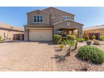 Inviting two-story home with a desert landscape, a brick driveway and a two car garage at 2765 E Gillcrest Rd, Gilbert, AZ 85298