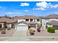Two-story home with a two-car garage, tiled roof, and well-maintained landscaping at 3144 W Maya Way, Phoenix, AZ 85083