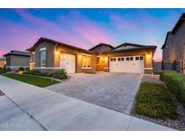 Beautiful single-Gathering home with a three-car garage and desert landscaping at sunset at 4606 S Ferric --, Mesa, AZ 85212