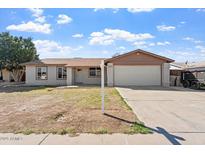 Charming single-story home with a well-maintained lawn and two-car garage at 5431 W Sierra St, Glendale, AZ 85304