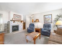 Cozy living room features a fireplace and comfortable seating arrangement at 5525 E Thomas Rd # N5, Phoenix, AZ 85018