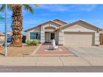 Charming single-story home featuring a desert landscape, palm tree, and a quaint water fountain at 6904 W Golden Ln, Peoria, AZ 85345