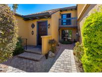 Inviting front entrance with charming walkway, lovely fountain, and a second-story balcony, creating a warm welcome at 7330 E Palo Verde Dr # 1, Scottsdale, AZ 85250