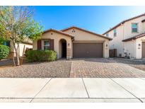 Charming single-story home featuring a desert landscape and a brick-paved driveway leading to a two-car garage at 8515 W Peppertree Ln, Glendale, AZ 85305