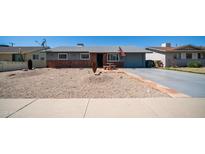 Charming single-story home featuring a low-maintenance gravel yard and inviting curb appeal at 1008 N La Jolla Blvd, Goodyear, AZ 85338