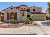 Two story stucco house with a terracotta roof and a two car garage at 12603 W Blackstone Ln, Peoria, AZ 85383