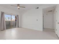 Bright bedroom featuring a sliding glass door leading to a balcony and a ceiling fan at 14950 W Mountain View Blvd # 5107, Surprise, AZ 85374