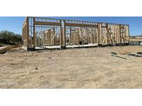 Wood framing for a new home shows the layout on a sunny day at 1800 W Caramel Ct, Queen Creek, AZ 85144