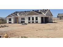 Under-construction single-Gathering home with the roof tiles ready to be installed at 1800 W Caramel Ct, Queen Creek, AZ 85144