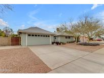 Charming single-story home with tidy front yard, desert landscaping, and two-car garage at 5165 E Tunder Dr, Phoenix, AZ 85044