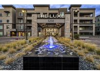 Stunning exterior view of 'The Luxe' building with a beautiful water feature and well-manicured landscaping at 5250 E Deer Valley Dr # 343, Phoenix, AZ 85054