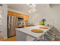 Bright kitchen with stainless steel appliances, bar seating, and ample countertop space at 8055 E Thomas Rd # E110, Scottsdale, AZ 85251