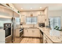 Bright kitchen showcases stainless steel appliances, granite countertops, and ample storage, perfect for culinary enthusiasts at 14000 N 94Th St # 3190, Scottsdale, AZ 85260