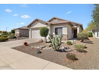 Charming single-story home with desert landscaping and a neutral-colored exterior at 21232 N 262Nd Dr, Buckeye, AZ 85396