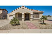 Charming single-story home featuring a well-manicured front yard and a welcoming entryway at 21492 E Roundup Way, Queen Creek, AZ 85142