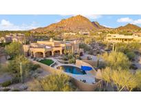 Aerial view of a luxurious desert home with a pool and mountain backdrop at 24200 N Alma School Rd # 4, Scottsdale, AZ 85255