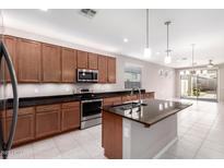 Modern kitchen with stainless steel appliances, granite countertops, and a central island at 3235 W Carter Rd, Phoenix, AZ 85041