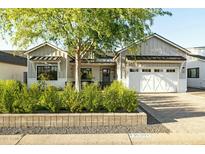 Charming home with white garage door, landscaped front yard, and craftsman-style architectural details at 3530 E Glenrosa Ave, Phoenix, AZ 85018