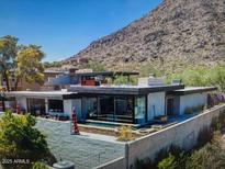 Modern home featuring a backyard pool and patio area with mountain views at 5434 E Lincoln Dr # 78, Paradise Valley, AZ 85253