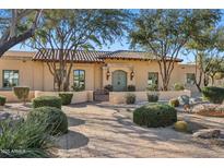 Charming home featuring desert landscaping, beautiful architectural details, and a private gated courtyard at 6915 E Gary Rd, Scottsdale, AZ 85254