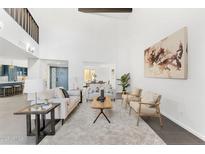 Bright living room boasts neutral furniture, high ceilings, and an open concept design with gray tiling at 7209 E Mcdonald Dr # 51, Scottsdale, AZ 85250