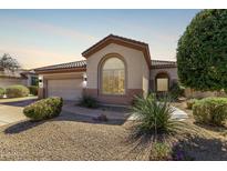 Charming single-story home features a desert-landscaped front yard, arched window, and a neutral color scheme at 8241 E Mohawk Ln, Scottsdale, AZ 85255