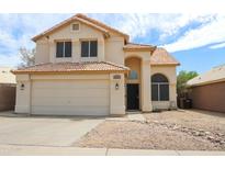 Inviting two-story home featuring a well-manicured yard and attached two-car garage at 8437 W Bluefield Ave, Peoria, AZ 85382