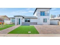 Beautiful home exterior featuring a balcony, manicured lawn, and brick accents, offering curb appeal at 92 N Palm St, Gilbert, AZ 85234