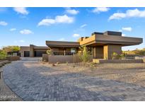 Stunning desert home showcasing modern architecture and meticulous landscape design with paver driveway at 10354 E Celestial Dr, Scottsdale, AZ 85262