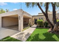 Charming home with an attached carport, well-maintained lawn, and mature trees at 1173 E Beryl Ave, Phoenix, AZ 85020