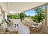 Relaxing covered patio with comfortable seating, overlooking scenic golf course views at 1202 Leisure World --, Mesa, AZ 85206
