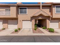 Charming townhome with private garage, covered entry, and well-maintained landscaping for a welcoming curb appeal at 1633 E Lakeside Dr # 106, Gilbert, AZ 85234