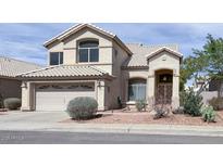 Charming two-story home featuring a tile roof, low-maintenance landscaping, and a two car garage at 228 W Bolero Dr, Tempe, AZ 85284