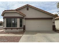 Charming single-story home with a two-car garage, bay window and desert landscaping in a residential neighborhood at 39894 N Fazio Ln, San Tan Valley, AZ 85140