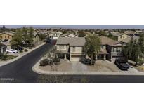 An aerial view of a two-story home with a tile roof in a suburban neighborhood at 40866 W Sanders Way, Maricopa, AZ 85138