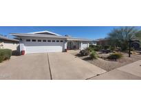 Charming single-story home with a well-manicured front yard, two car garage, and lovely desert landscaping at 4734 E Florian Cir, Mesa, AZ 85206