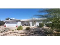 Beautiful single-story home with a well-kept yard, desert landscaping, and a spacious two-car garage at 4734 E Florian Cir, Mesa, AZ 85206