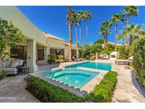 Inviting pool and spa area surrounded by lush landscaping and tall palm trees at 7380 E Turquoise Ave, Scottsdale, AZ 85258