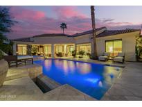Luxurious backyard pool illuminated against a vibrant dusk sky, offering a serene oasis at 7380 E Turquoise Ave, Scottsdale, AZ 85258