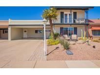 Charming two-story home with a balcony, desert landscaping, and covered parking at 7642 E Pasadena Ave, Scottsdale, AZ 85250