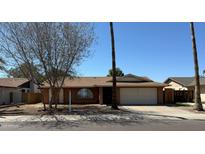 Charming single-level home with a two-car garage, desert landscaping, and a cozy front yard at 10014 N 44Th Dr, Glendale, AZ 85302