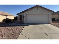 Charming single-story home featuring a two-car garage, desert landscaping, and a welcoming front entrance at 12233 W Aster Dr, El Mirage, AZ 85335