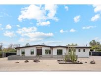 Charming desert home with a modern design, xeriscaping, and privacy wall at 12416 N 65Th Pl, Scottsdale, AZ 85254