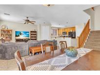 Open-concept living room flows into the kitchen, featuring a staircase and comfortable seating area at 1265 S Aaron St # 285, Mesa, AZ 85209